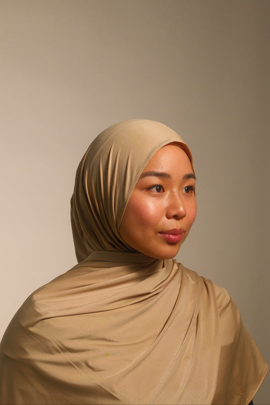 Hijabi women wearing beige liquid fluid jersey hijab by the brand malika the collection