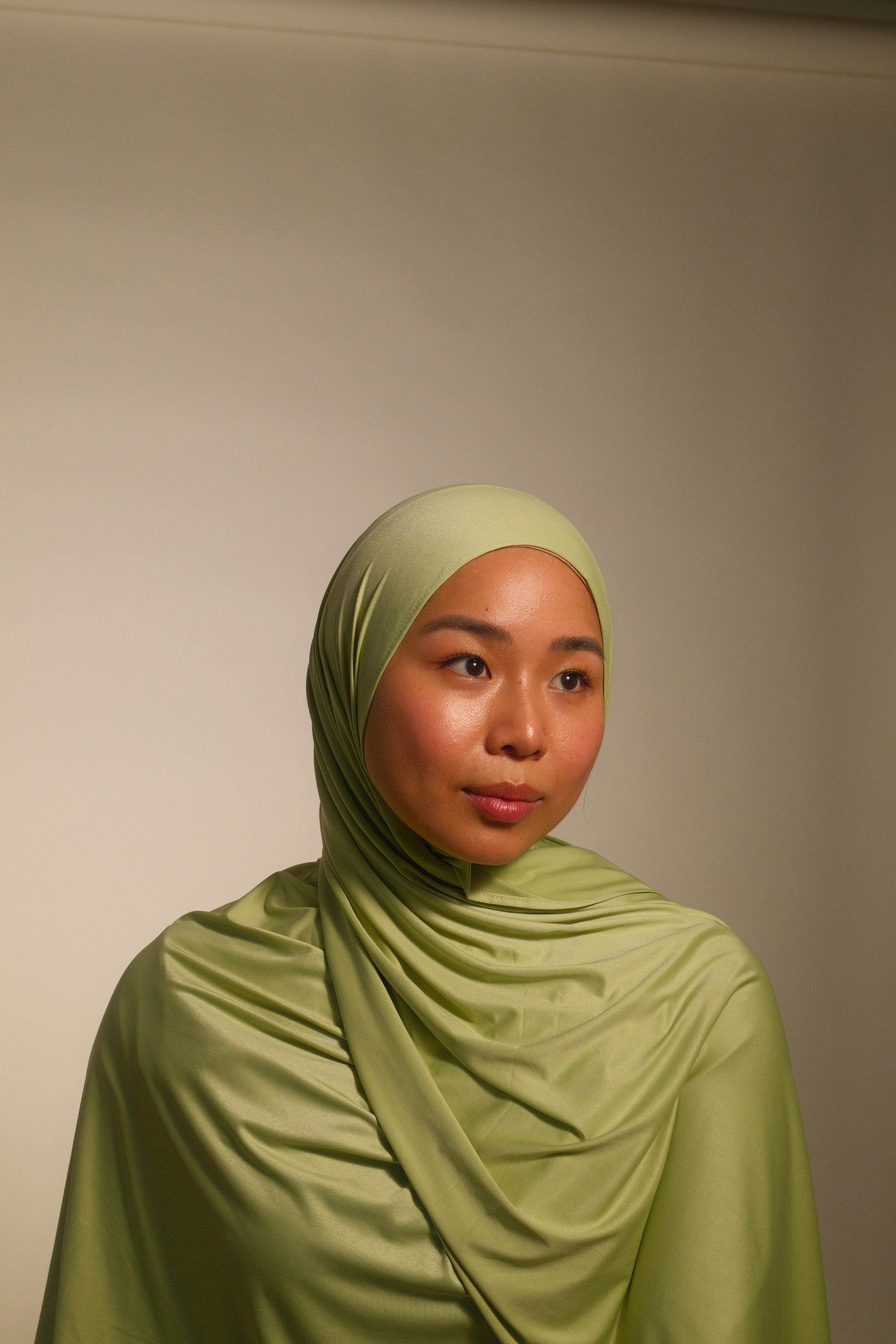 Hijabi women wearing premium liquid fluid jersey by the brand malika the collection